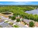 Aerial view of a residential neighborhood featuring a lake and surrounding trees with the home's location marked at 555 Carey Way, Orlando, FL 32825