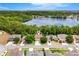 Aerial view of a home with a lake in the background and lush greenery surrounding the neighborhood at 555 Carey Way, Orlando, FL 32825