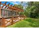 Fenced backyard featuring an outdoor kitchen, patio area, and lush greenery for relaxation and entertainment at 555 Carey Way, Orlando, FL 32825