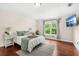 Spacious bedroom featuring hardwood floors and large window with backyard view at 555 Carey Way, Orlando, FL 32825