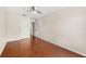 A spacious bedroom with hardwood floors and an overhead fan offers a neutral color pallette and lots of natural light at 555 Carey Way, Orlando, FL 32825