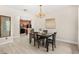 Dining area with wood table, comfortable chairs, wood floors, and kitchen view at 555 Carey Way, Orlando, FL 32825