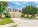 A bright two-story home with a well-maintained lawn and a three-car garage on a sunny day at 555 Carey Way, Orlando, FL 32825