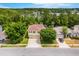 Charming two-story home with an attached two-car garage surrounded by lush green trees and landscaping at 555 Carey Way, Orlando, FL 32825
