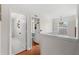 Upstairs hallway featuring hardwood floors and doorways leading to other rooms at 555 Carey Way, Orlando, FL 32825