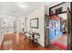 Hallway featuring hardwood floors, an ornate table, and an inviting open doorway at 555 Carey Way, Orlando, FL 32825