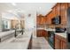 Well-equipped kitchen featuring quartz countertops, wooden cabinetry, and stainless steel appliances at 555 Carey Way, Orlando, FL 32825