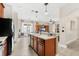 Open-concept kitchen with stainless steel appliances, a center island, and a view into the living area at 555 Carey Way, Orlando, FL 32825