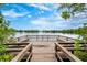 Scenic lake view from a wooden deck with seating, perfect for relaxation and enjoying the waterfront at 555 Carey Way, Orlando, FL 32825