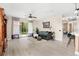 Bright and airy living room with a ceiling fan, hardwood floors, and a sliding glass door to the backyard at 555 Carey Way, Orlando, FL 32825
