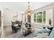 Bright living room with hardwood floors, large windows, and elegant chandeliers at 555 Carey Way, Orlando, FL 32825