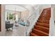 Open-concept living room with hardwood stairs, a chandelier, and ample natural light at 555 Carey Way, Orlando, FL 32825