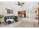 Open-concept living room with wood laminate flooring and a comfortable seating area near the kitchen at 555 Carey Way, Orlando, FL 32825