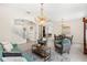 Open-concept living area with chandeliers, wood floors, arched openings, and comfortable sofa at 555 Carey Way, Orlando, FL 32825