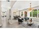 Bright living room with wood floors, large windows, chandeliers, and seating at 555 Carey Way, Orlando, FL 32825