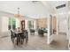 Open-concept living and dining area with hardwood floors, updated chandeliers, and natural light at 555 Carey Way, Orlando, FL 32825