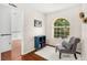Home office area with a large window, chair, and hardwood floors at 555 Carey Way, Orlando, FL 32825