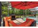 Screened-in pool area with comfortable seating, fireplace, tropical landscaping, and scenic backyard views at 555 Carey Way, Orlando, FL 32825