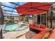 This covered pool features a waterfall, outdoor seating and lush landscaping at 555 Carey Way, Orlando, FL 32825