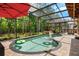 This covered pool features a waterfall and lush landscaping at 555 Carey Way, Orlando, FL 32825