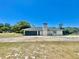 Single-story home with a two-car garage, neutral colors, and a spacious lot, perfect for outdoor activities at 6001 Beau Ln, Orlando, FL 32808