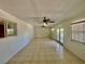 Spacious living room with tile floors, multiple ceiling fans and large windows, creating a bright and airy atmosphere at 6001 Beau Ln, Orlando, FL 32808
