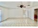 Bright living room with neutral paint, tile floors, a ceiling fan and large windows, offering a comfortable and inviting space at 6001 Beau Ln, Orlando, FL 32808