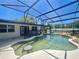 A refreshing private swimming pool with stone accents enclosed in a screened lanai at 6001 Beau Ln, Orlando, FL 32808