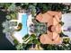 Aerial view of the community pool, clubhouse, lush landscaping and parking area at 6117 Metrowest Blvd # 106, Orlando, FL 32835