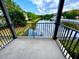 Scenic balcony view overlooking a tranquil pond with lush greenery and bright blue skies at 6117 Metrowest Blvd # 106, Orlando, FL 32835
