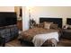 Cozy bedroom with a leopard print comforter, dark wood floors, and a view into a bathroom at 6117 Metrowest Blvd # 106, Orlando, FL 32835