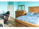 Furnished bedroom with bright blue walls and wooden bed frame at 6117 Metrowest Blvd # 106, Orlando, FL 32835