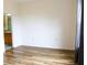 View of a bedroom features wood-look floors and bathroom access at 6117 Metrowest Blvd # 106, Orlando, FL 32835