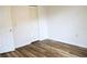 Bright bedroom with wood floors, featuring a bifold closet door and neutral color scheme at 6117 Metrowest Blvd # 106, Orlando, FL 32835