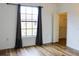 Bright bedroom with a large window and view. Features wood-look floors and ample natural light at 6117 Metrowest Blvd # 106, Orlando, FL 32835