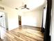 Bright bedroom with light walls, wood-look flooring, a ceiling fan, and window plus a bathroom at 6117 Metrowest Blvd # 106, Orlando, FL 32835