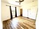Bedroom featuring wood-look flooring, large window, closet and neutral wall color at 6117 Metrowest Blvd # 106, Orlando, FL 32835