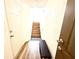 View of the entryway and staircase, featuring wood-look floors and a small bench at 6117 Metrowest Blvd # 106, Orlando, FL 32835