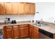 Spacious kitchen with wooden cabinets, granite countertops, and stainless steel appliances at 6117 Metrowest Blvd # 106, Orlando, FL 32835