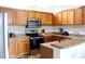 Well-equipped kitchen with stainless steel appliances, ample wooden cabinetry, and tiled backsplash at 6117 Metrowest Blvd # 106, Orlando, FL 32835