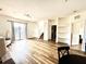 Bright, open-concept living area with wood-look floors and access to outdoor balcony at 6117 Metrowest Blvd # 106, Orlando, FL 32835