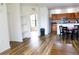 Bright living room with wood floors, shelving, and open access to a well-equipped kitchen and a sunlit den at 6117 Metrowest Blvd # 106, Orlando, FL 32835