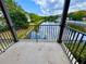 Balcony view of a serene community pond with lush greenery and neighborhood buildings at 6117 Metrowest Blvd # 106, Orlando, FL 32835
