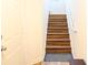 Staircase with beautiful wood steps ascending, featuring a sturdy white handrail and natural light at 6117 Metrowest Blvd # 106, Orlando, FL 32835