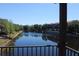 Balcony view of a wide canal with trees, landscaping, and three-story townhomes along the shore at 6117 Metrowest Blvd # 106, Orlando, FL 32835