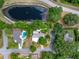 An aerial shot showcases a home with a pool, pond, and the surrounding neighborhood at 808 Denton Rd, Winter Park, FL 32792