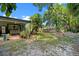 The spacious backyard has mature trees, a stone fire pit, and a covered patio at 808 Denton Rd, Winter Park, FL 32792