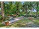 The backyard has a brick-lined area with a stone fire pit and lush landscaping at 808 Denton Rd, Winter Park, FL 32792