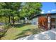The grassy backyard features a wooden privacy screen and an outdoor shower at 808 Denton Rd, Winter Park, FL 32792