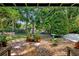 Lush backyard features a rock garden, mature trees, and brick trim at 808 Denton Rd, Winter Park, FL 32792
